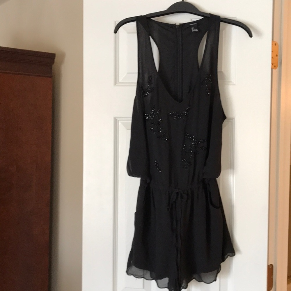 Very cute black jumpsuit with beads.